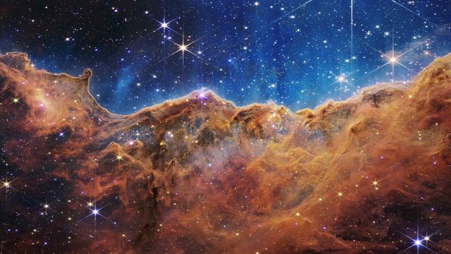 The Cosmic Cliffs, the edge of a star-forming region in the Carina Nebula, imaged by the James Webb Space Telescope