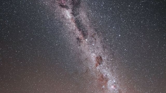 The Milky Way arching over an observatory under a dark sky in Chile